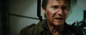 Movie still from “Run All Night” (2015), directed by Jaume Collet-Serra – A person with a face covered in blood; Close Up shot, Over the shoulder angle