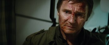Movie still from “Run All Night” (2015), directed by Jaume Collet-Serra – A person with blood on his face; Close Up shot, Low angle