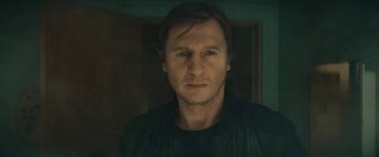 Movie still from “Run All Night” (2015), directed by Jaume Collet-Serra – A person with long hair; Close Up shot, Low angle