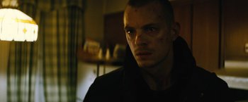 Movie still from “Run All Night” (2015), directed by Jaume Collet-Serra – A person wearing a black shirt; Close Up shot, Low angle