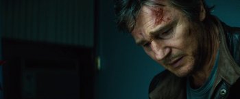 Movie still from “Run All Night” (2015), directed by Jaume Collet-Serra – A person with bruises on his face; Close Up shot, Low angle
