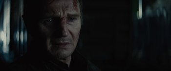 Movie still from “Run All Night” (2015), directed by Jaume Collet-Serra – A person with blood on his face; Close Up shot, Over the shoulder angle