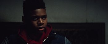 Movie still from “Run All Night” (2015), directed by Jaume Collet-Serra – A young man is looking into the camera; Close Up shot, Low angle