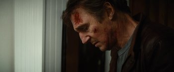Movie still from “Run All Night” (2015), directed by Jaume Collet-Serra – A person with blood on his face; Close Up shot, Low angle