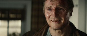 Movie still from “Run All Night” (2015), directed by Jaume Collet-Serra – A person wearing a brown jacket; Close Up shot, Over the shoulder angle