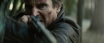 Movie still from “Run All Night” (2015), directed by Jaume Collet-Serra – A person holding a gun; Close Up shot, Low angle