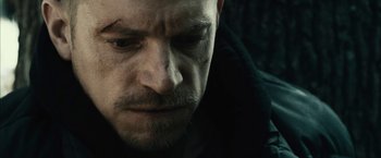 Movie still from “Run All Night” (2015), directed by Jaume Collet-Serra – A man's face in a dark room; Extreme Close Up shot, Low angle