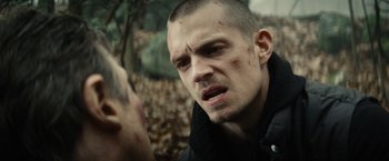 Movie still from “Run All Night” (2015), directed by Jaume Collet-Serra – A person with a face covered in blood; Close Up shot, Over the shoulder angle