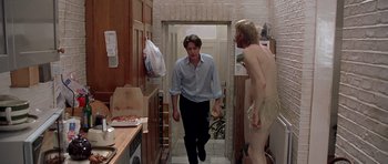Movie still from “Notting Hill” (1999), directed by Roger Michell – A man walking down the hall way of a house; Wide shot, Over the shoulder angle