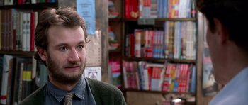 Movie still from “Notting Hill” (1999), directed by Roger Michell – A person in a room filled with bookshelves; Close Up shot, Over the shoulder angle