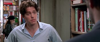 Movie still from “Notting Hill” (1999), directed by Roger Michell – A person wearing a blue shirt; Close Up shot, Over the shoulder angle