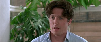 Movie still from “Notting Hill” (1999), directed by Roger Michell – A person wearing a blue shirt; Close Up shot, Over the shoulder angle