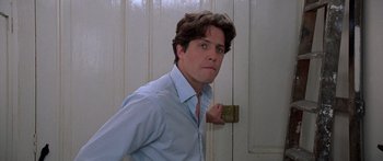 Movie still from “Notting Hill” (1999), directed by Roger Michell – A man standing in front of a white door; Close Up shot, Low angle
