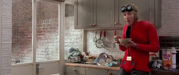 Movie still from “Notting Hill” (1999), directed by Roger Michell – A woman standing in a kitchen holding a plate; Medium shot, Low angle
