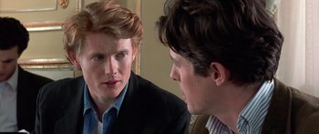 Movie still from “Notting Hill” (1999), directed by Roger Michell – Two young men are looking at each other in the mirror; Close Up shot, Over the shoulder angle