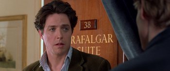 Movie still from “Notting Hill” (1999), directed by Roger Michell – A person in front of a building; Close Up shot, Over the shoulder angle