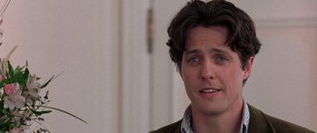 Movie still from “Notting Hill” (1999), directed by Roger Michell – A person wearing a shirt and a jacket; Close Up shot, Over the shoulder angle