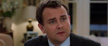 Movie still from “Notting Hill” (1999), directed by Roger Michell – A person wearing a suit and tie; Close Up shot, Low angle