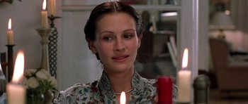 Movie still from “Notting Hill” (1999), directed by Roger Michell – A beautiful woman holding a candle in front of a window; Close Up shot, Over the shoulder angle