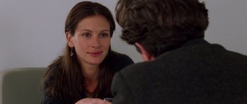 Movie still from “Notting Hill” (1999), directed by Roger Michell – A woman sitting in front of a man in front of a mirror; Close Up shot, Over the shoulder angle
