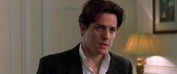 Movie still from “Notting Hill” (1999), directed by Roger Michell – A person wearing a suit; Close Up shot, Low angle