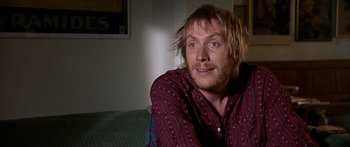 Movie still from “Notting Hill” (1999), directed by Roger Michell – A person sitting on a couch; Close Up shot, High angle