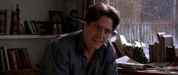 Movie still from “Notting Hill” (1999), directed by Roger Michell – A person sitting in a room; Close Up shot, Low angle