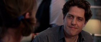 Movie still from “Notting Hill” (1999), directed by Roger Michell – A person wearing a gray shirt; Close Up shot, Over the shoulder angle