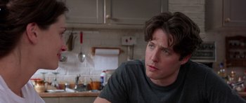 Movie still from “Notting Hill” (1999), directed by Roger Michell – A person sitting in a kitchen; Close Up shot, Over the shoulder angle
