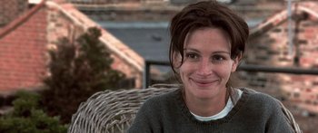 Movie still from “Notting Hill” (1999), directed by Roger Michell – A person sitting on a chair; Close Up shot, Over the shoulder angle
