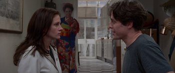 Movie still from “Notting Hill” (1999), directed by Roger Michell – A man and a woman are standing in front of each other; Medium shot, Over the shoulder angle