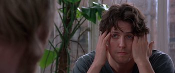 Movie still from “Notting Hill” (1999), directed by Roger Michell – A person with his hand on his head; Close Up shot, Low angle