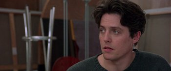 Movie still from “Notting Hill” (1999), directed by Roger Michell – A person wearing a green shirt; Close Up shot, Over the shoulder angle
