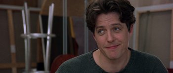 Movie still from “Notting Hill” (1999), directed by Roger Michell – A person wearing a sweater; Close Up shot, Over the shoulder angle