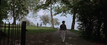 Movie still from “Notting Hill” (1999), directed by Roger Michell – A woman walking down a path in a park; Wide shot, High angle