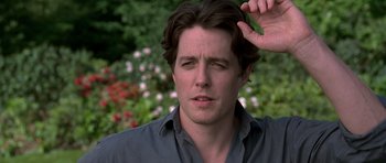 Movie still from “Notting Hill” (1999), directed by Roger Michell – A person holding his hand up to his head; Close Up shot, Over the shoulder angle
