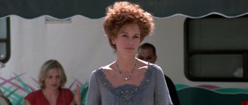 Movie still from “Notting Hill” (1999), directed by Roger Michell – A woman in a blue dress with a necklace; Close Up shot, Low angle