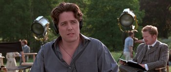 Movie still from “Notting Hill” (1999), directed by Roger Michell – A person wearing headphones; Close Up shot, Low angle