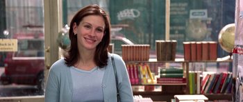 Movie still from “Notting Hill” (1999), directed by Roger Michell – A woman standing in front of a book store; Medium shot, Over the shoulder angle