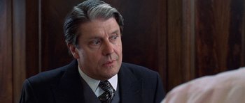 Movie still from “Notting Hill” (1999), directed by Roger Michell – A person wearing a suit and tie; Close Up shot, Over the shoulder angle