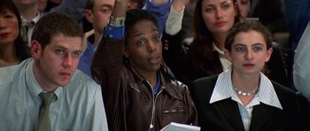 Movie still from “Notting Hill” (1999), directed by Roger Michell – A man in a brown leather jacket raising his hands; Close Up shot, High angle