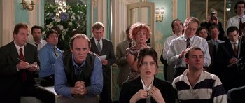 Movie still from “Notting Hill” (1999), directed by Roger Michell – A group of people standing around each other; Medium shot, Over the shoulder angle
