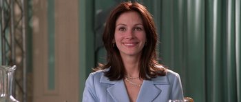 Movie still from “Notting Hill” (1999), directed by Roger Michell – A woman in a blue jacket smiling for the camera; Close Up shot, Low angle
