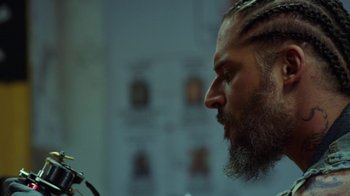Movie still from “Sabotage” (2014), directed by David Ayer – A man with a long beard looking into a mirror; Close Up shot, Over the shoulder angle