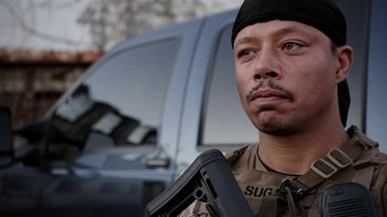 Movie still from “Sabotage” (2014), directed by David Ayer – A man holding a gun while standing next to a truck; Close Up shot, Over the shoulder angle