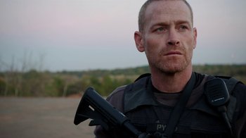 Movie still from “Sabotage” (2014), directed by David Ayer – A person holding a gun; Close Up shot, Over the shoulder angle