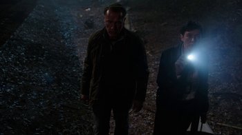 Movie still from “Sabotage” (2014), directed by David Ayer – A man and a woman are standing in the dark; Medium shot, High angle