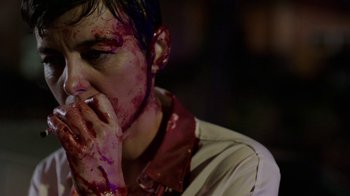 Movie still from “Sabotage” (2014), directed by David Ayer – A man with blood all over his face and hands; Close Up shot, Over the shoulder angle