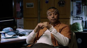 Movie still from “Sabotage” (2014), directed by David Ayer – A man sitting at a desk in a room; Medium shot, Over the shoulder angle