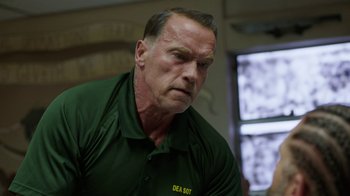 Movie still from “Sabotage” (2014), directed by David Ayer – A person wearing a green shirt; Close Up shot, Over the shoulder angle
